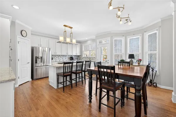a view of a dining room with furniture window and wooden floor