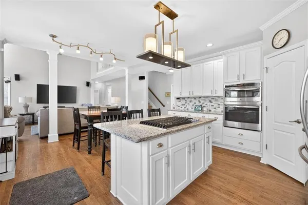 a bedroom with a bed window and wooden floor