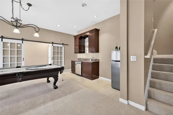 a view of a street with a fence and trees