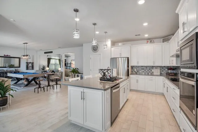 a kitchen with counter top space a sink stainless steel appliances and cabinets