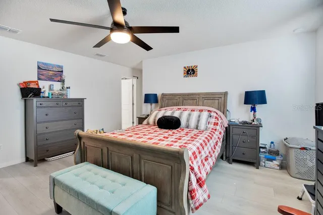 a bedroom with a bed and a chandelier