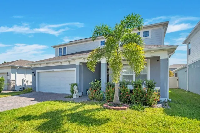a view of a house with a yard and plants
