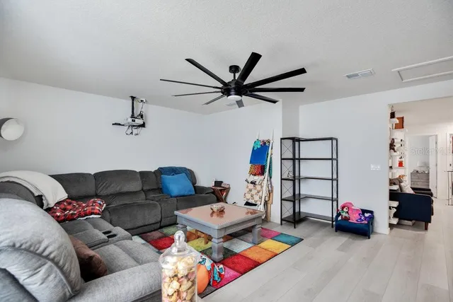 a living room with furniture and a chandelier