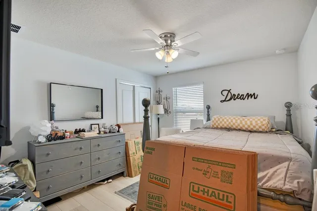 a bedroom with a bed and a chandelier