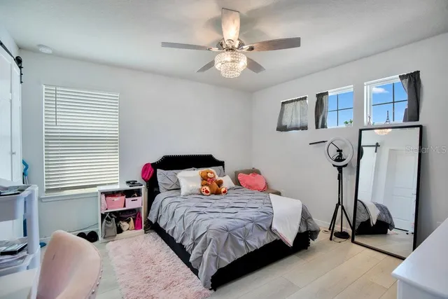 a bedroom with a bed and a chandelier