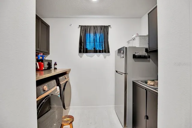 a kitchen with a refrigerator and cabinets