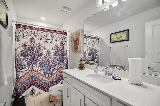 a bathroom with a sink toilet and a mirror