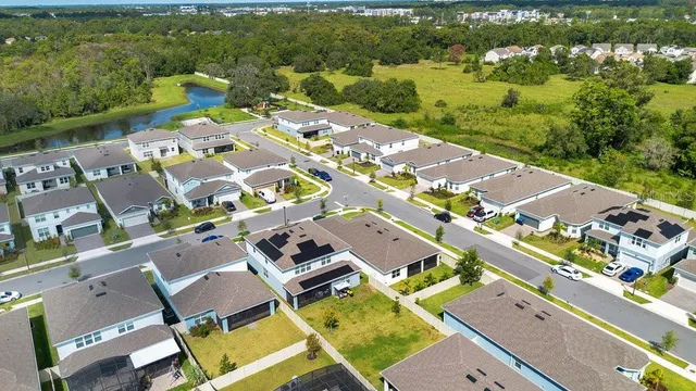 an aerial view of a house with a swimming pool and outdoor space