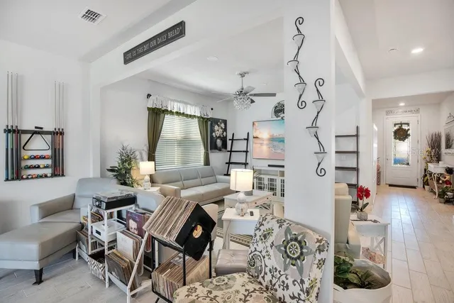 a living room with furniture and a chandelier