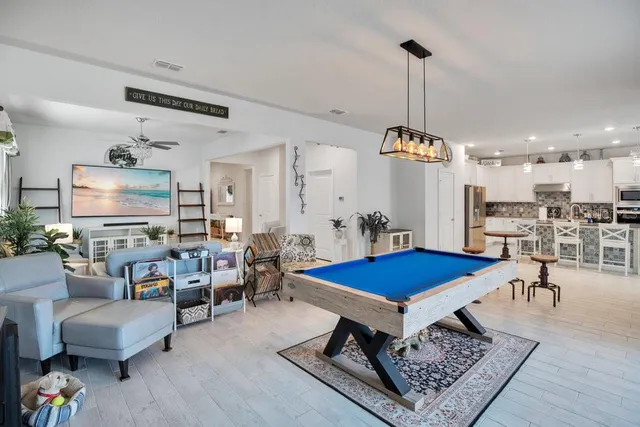 a living room with dining table and a table