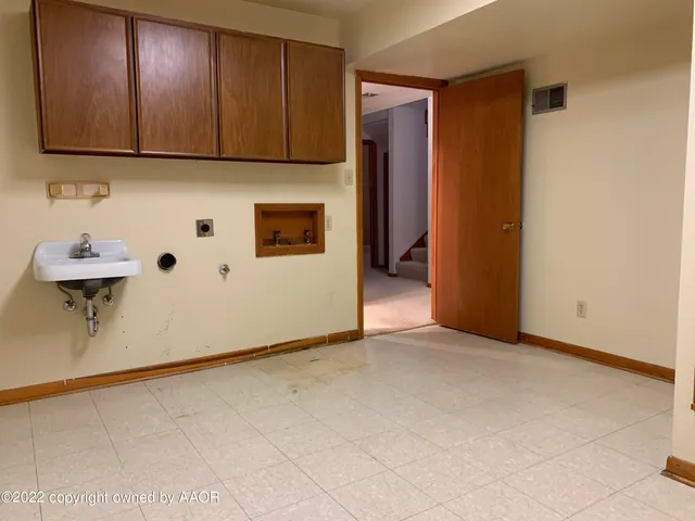 a view of a room with wooden wall and a window