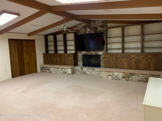 a view of a livingroom with furniture and a flat screen tv