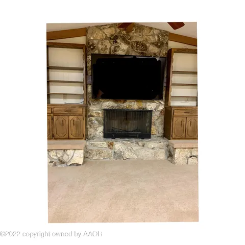 a view of living room with a flat screen tv and a fireplace