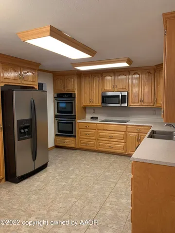 a kitchen with stainless steel appliances a refrigerator and a stove