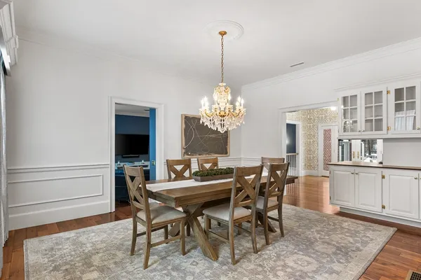 a view of a dining room with furniture and chandelier