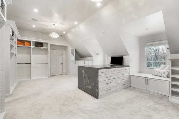 an empty room with windows and cabinet