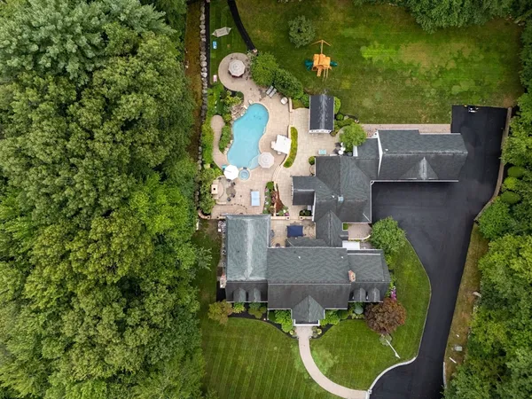 an aerial view of a house with outdoor space pool seating area and yard