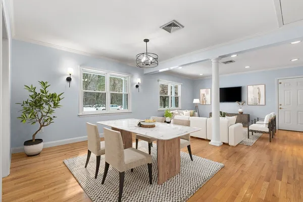 a view of a dining room with furniture window and wooden floor