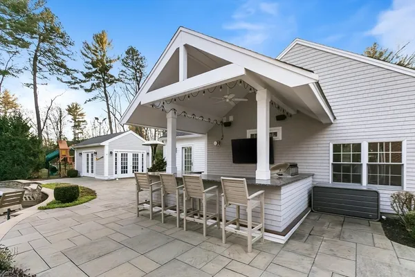 a view of a patio with table and chairs and potted plants