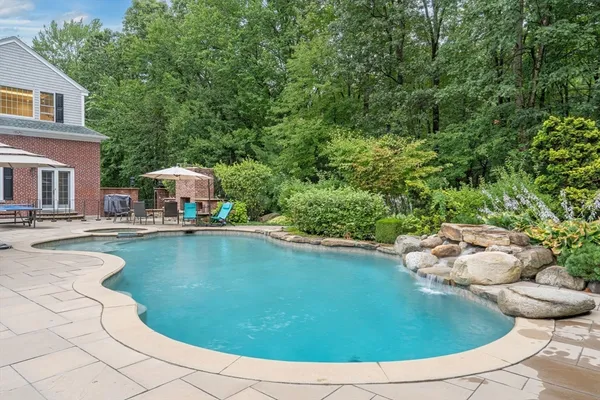 a view of a swimming pool with lounge chair