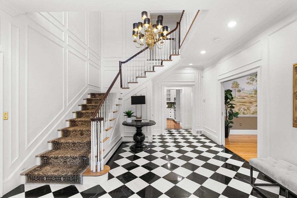 40 Grandview Road Chelmsford, MA 01824 - Photo 4 of 42 a hallway with a black white checkered floor and a potted plant