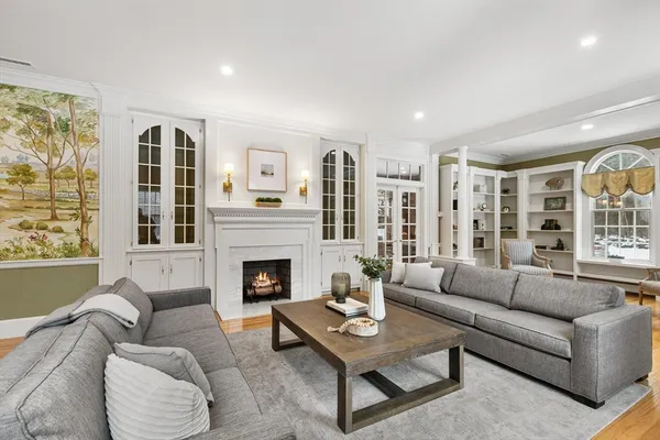 a living room with furniture fireplace and window