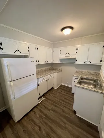 a kitchen with wooden cabinets and white appliances