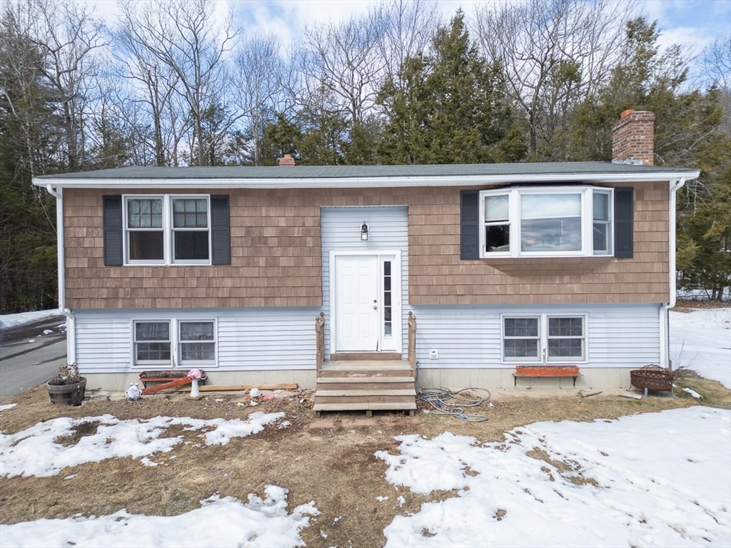 45 Watatic Mountain Road Ashby, MA 01431 - Photo 1 of 31 a front view of a house with a yard covered in snow
