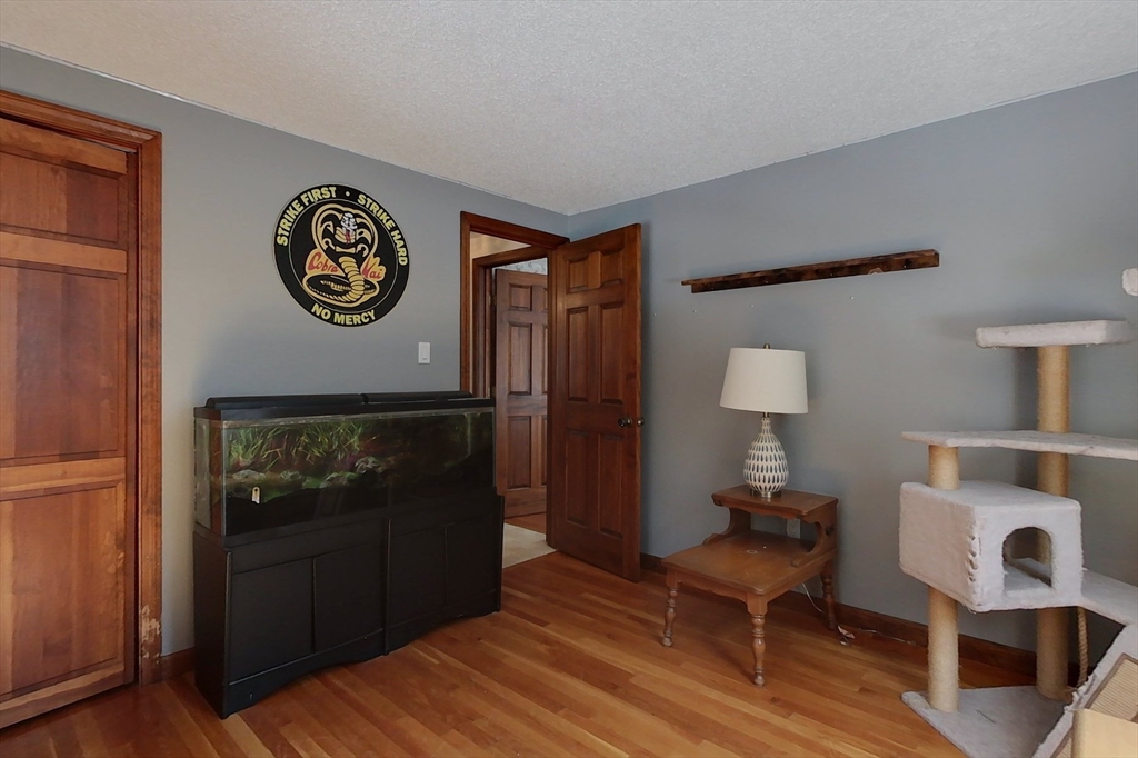 45 Watatic Mountain Road Ashby, MA 01431 - Photo 15 of 31 a view of a hallway with wooden floor and a workspace