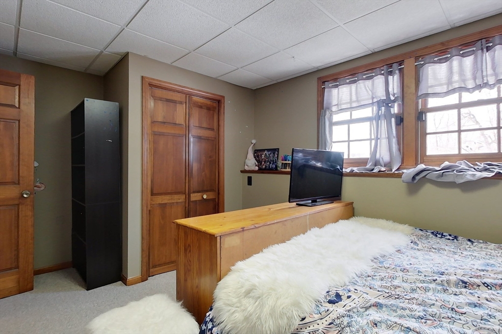 45 Watatic Mountain Road Ashby, MA 01431 - Photo 18 of 31 a bedroom with a bed and a dresser next to a window