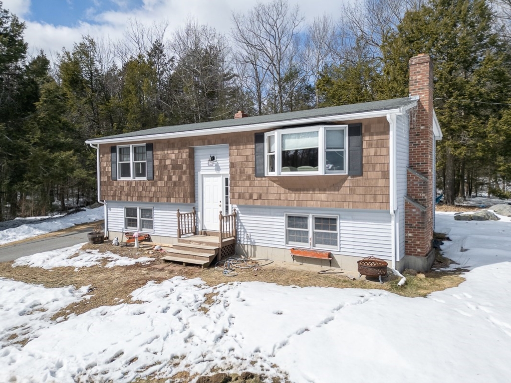 45 Watatic Mountain Road Ashby, MA 01431 - Photo 23 of 31 a front view of a house with a yard covered with snow and trees