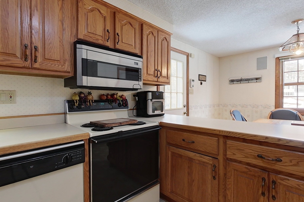 45 Watatic Mountain Road Ashby, MA 01431 - Photo 4 of 31 a kitchen with stainless steel appliances granite countertop a stove a sink and a microwave