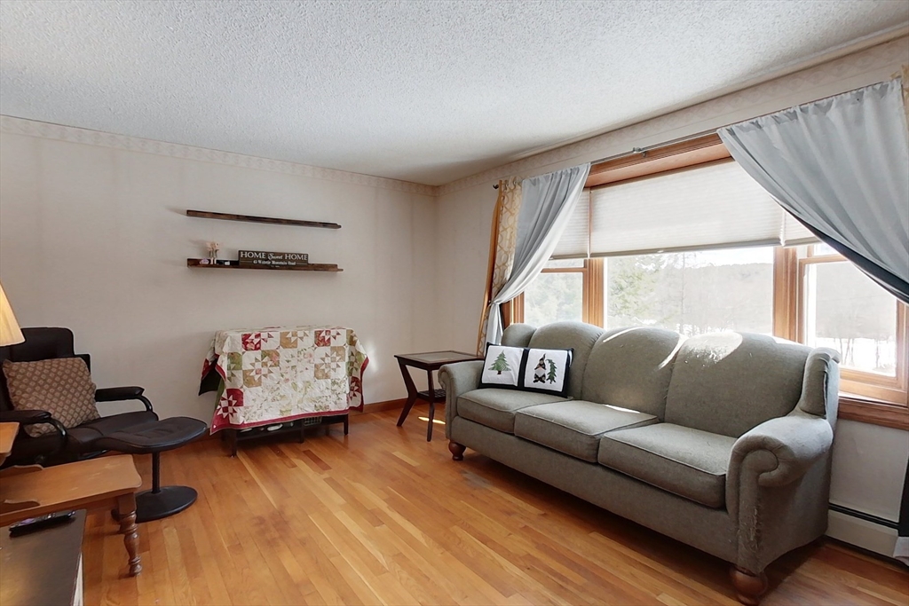 45 Watatic Mountain Road Ashby, MA 01431 - Photo 8 of 31 a living room with furniture and a window
