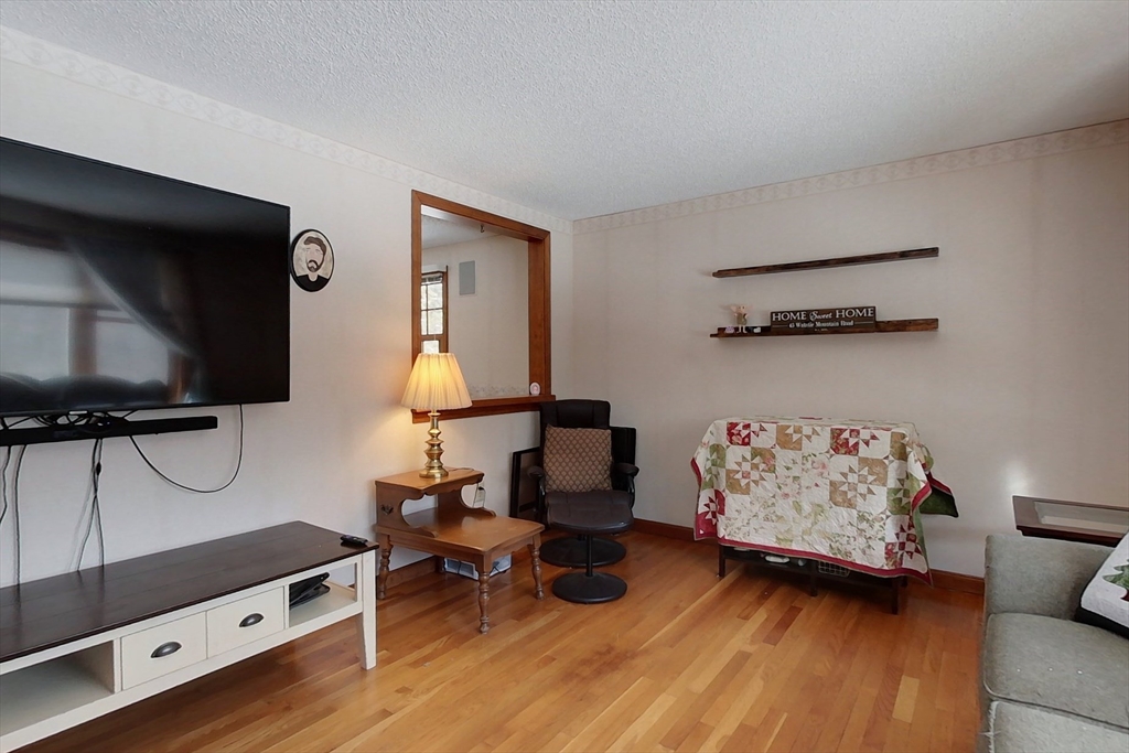 45 Watatic Mountain Road Ashby, MA 01431 - Photo 9 of 31 a living room with furniture and a flat screen tv