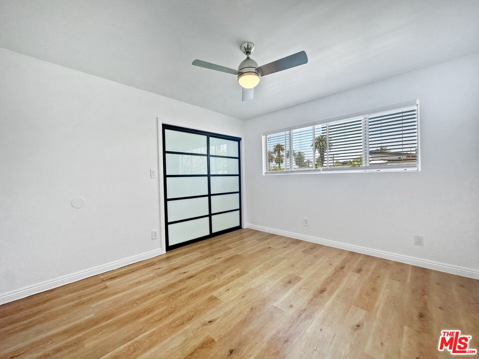 2841 South Sycamore Avenue, Unit 3 Los Angeles, CA 90016 - Photo 12 of 16 a view of a livingroom with wooden floor and a ceiling fan