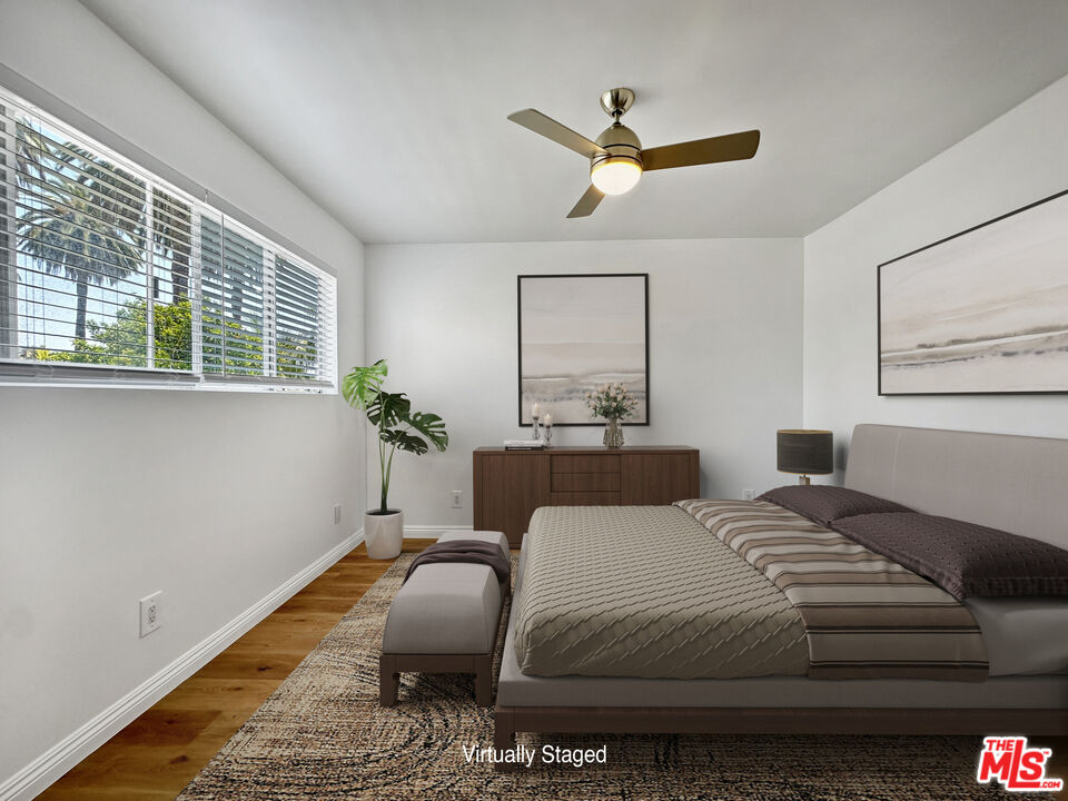 2841 South Sycamore Avenue, Unit 3 Los Angeles, CA 90016 - Photo 13 of 16 a bedroom with a bed dresser flowerpot and window