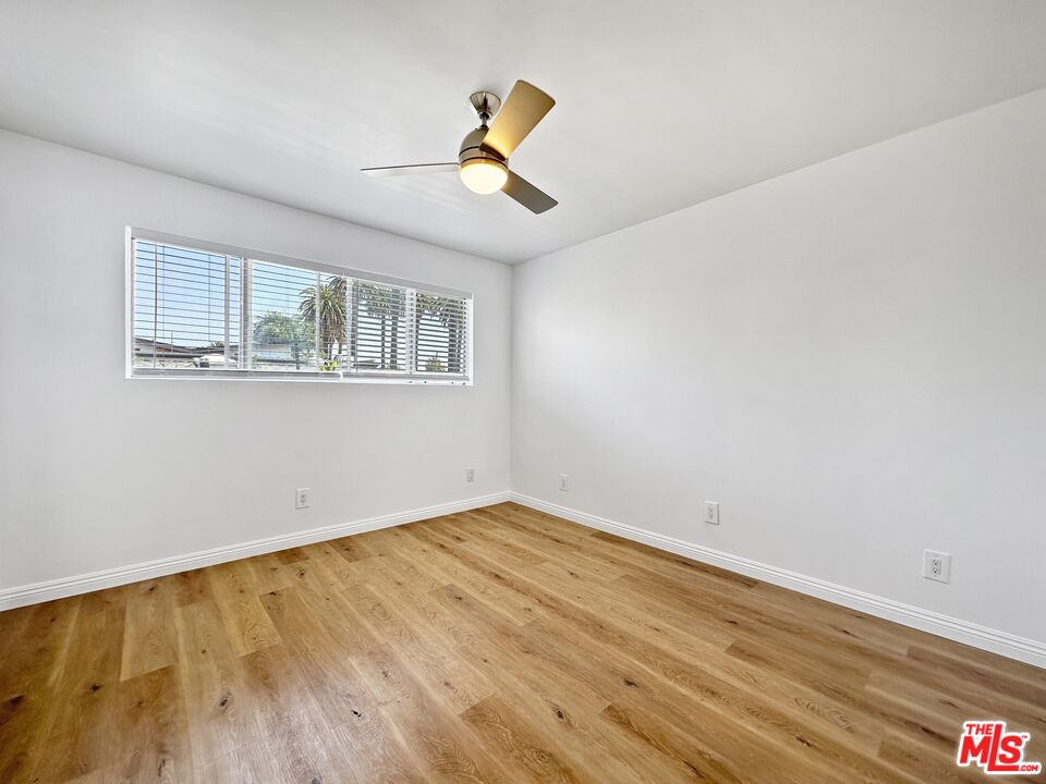 2841 South Sycamore Avenue, Unit 3 Los Angeles, CA 90016 - Photo 14 of 16 a view of empty room with wooden floor and windows