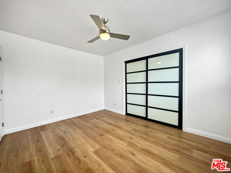 2841 South Sycamore Avenue, Unit 3 Los Angeles, CA 90016 - Photo 15 of 16 a view of a big room with wooden floor and windows