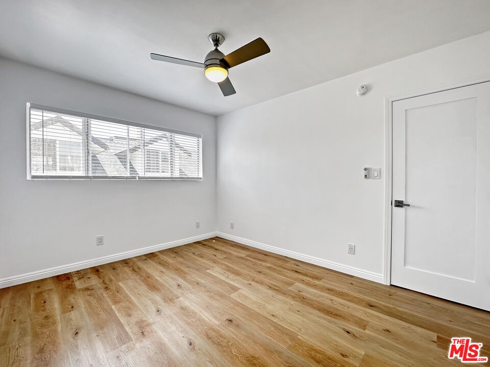 2841 South Sycamore Avenue, Unit 3 Los Angeles, CA 90016 - Photo 2 of 16 an empty room with wooden floor fan and windows