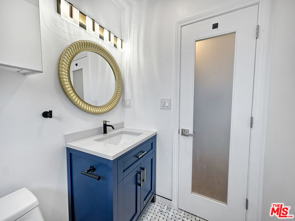 2841 South Sycamore Avenue, Unit 3 Los Angeles, CA 90016 - Photo 8 of 16 a bathroom with a sink a toilet and a mirror