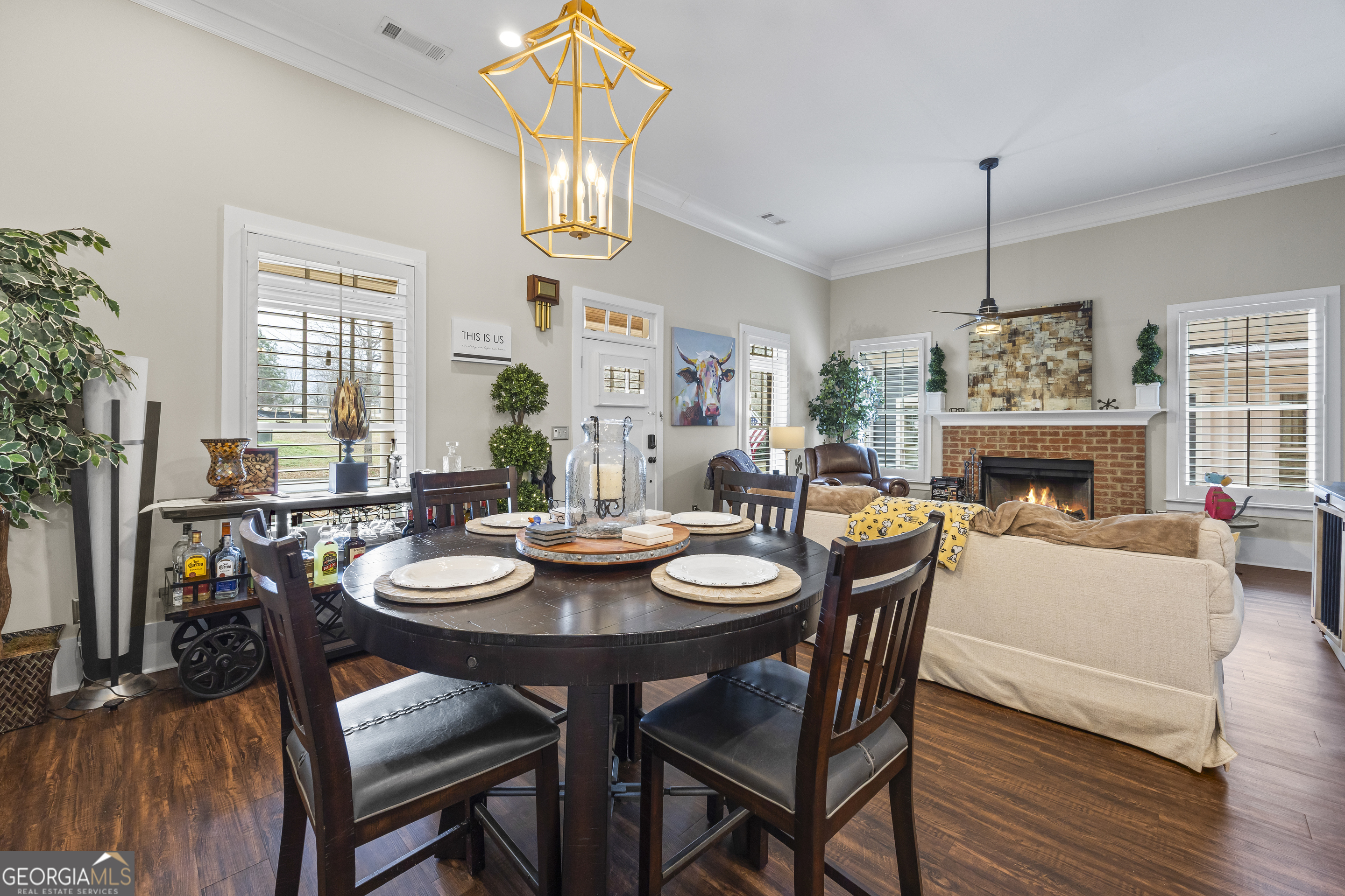 4121 North Swann Street Covington, GA 30014 - Photo 12 of 46 a dining room with furniture a chandelier and wooden floor