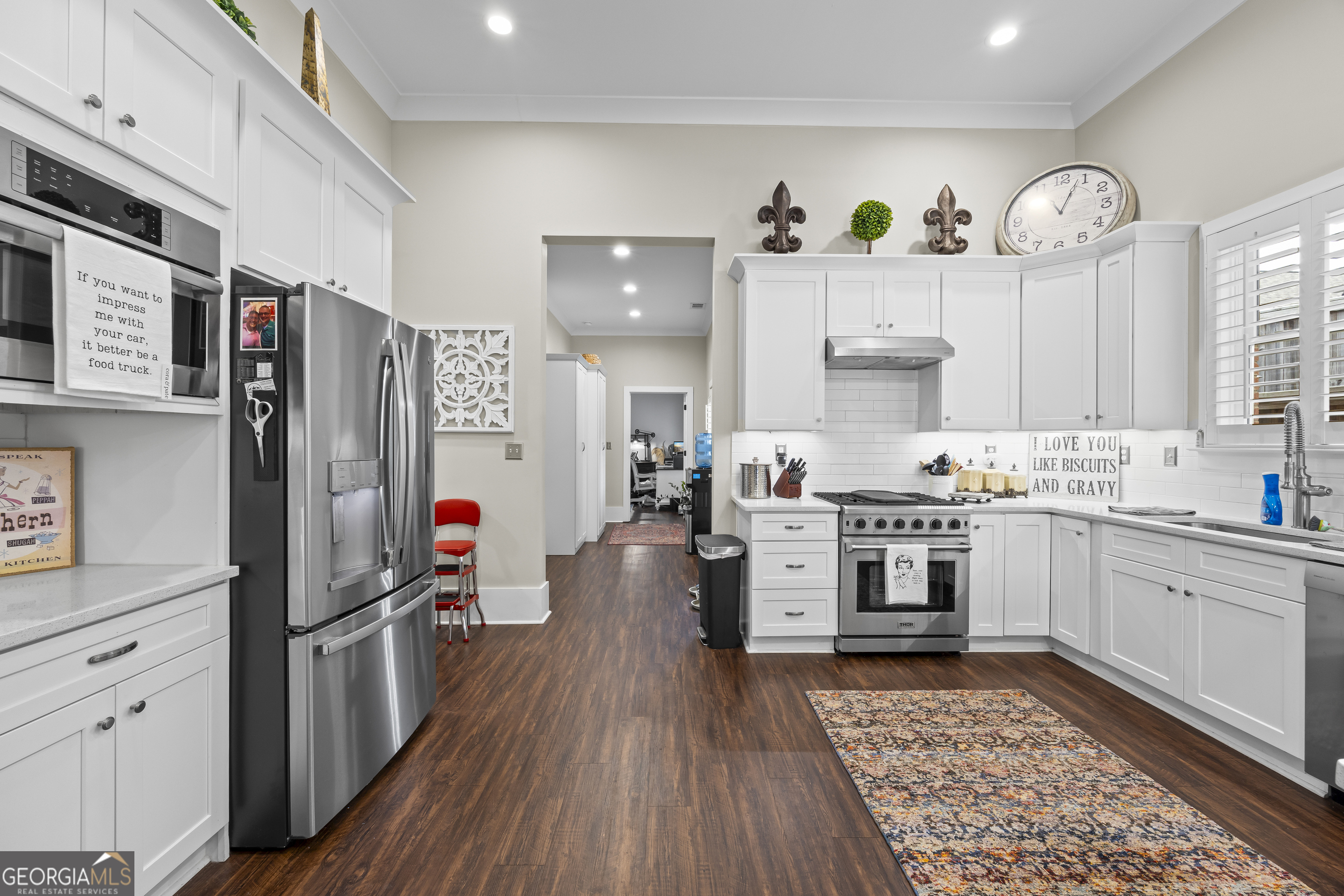 4121 North Swann Street Covington, GA 30014 - Photo 14 of 46 a kitchen with cabinets and wooden floor