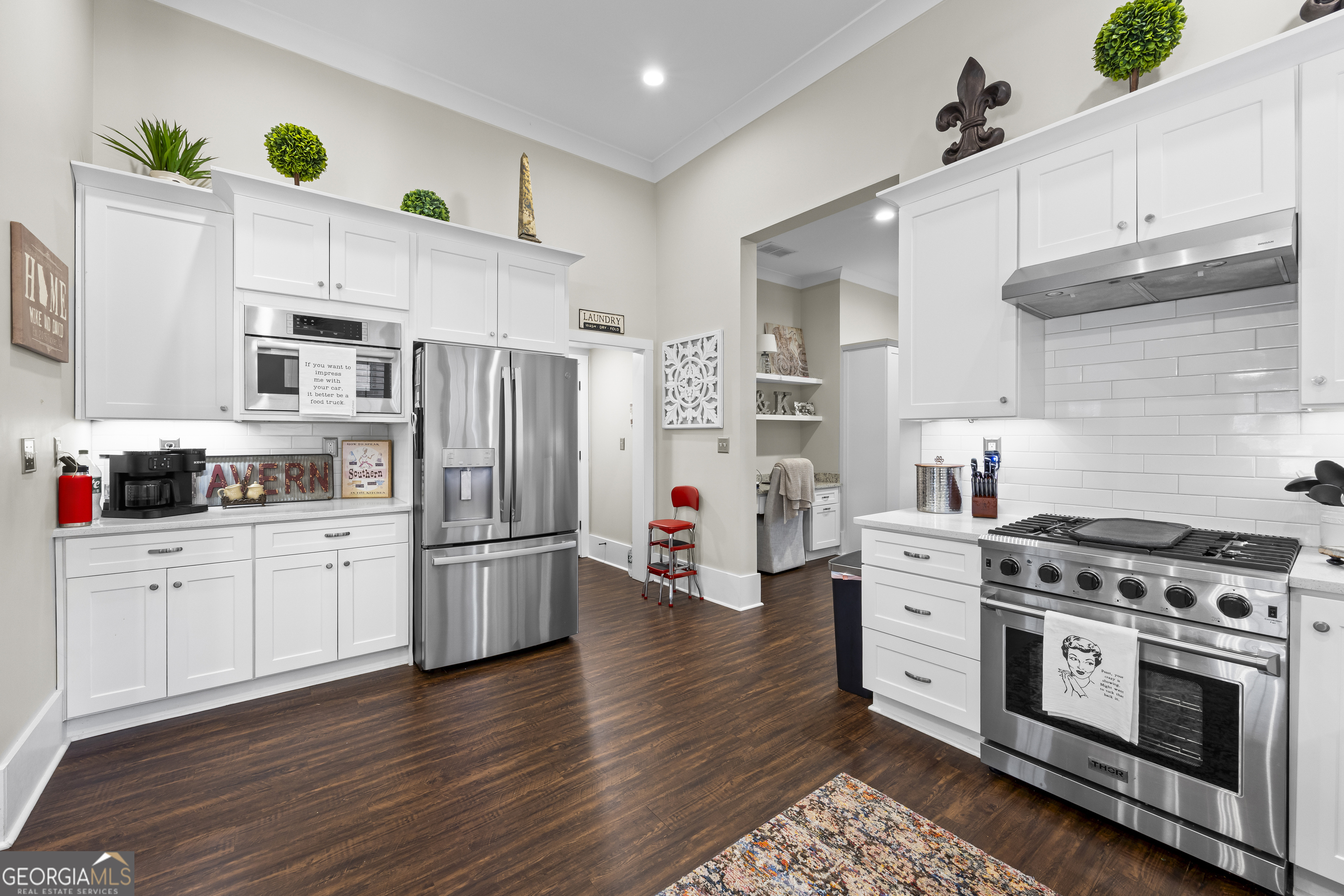 4121 North Swann Street Covington, GA 30014 - Photo 16 of 46 a kitchen with stainless steel appliances a stove a sink cabinets and a refrigerator