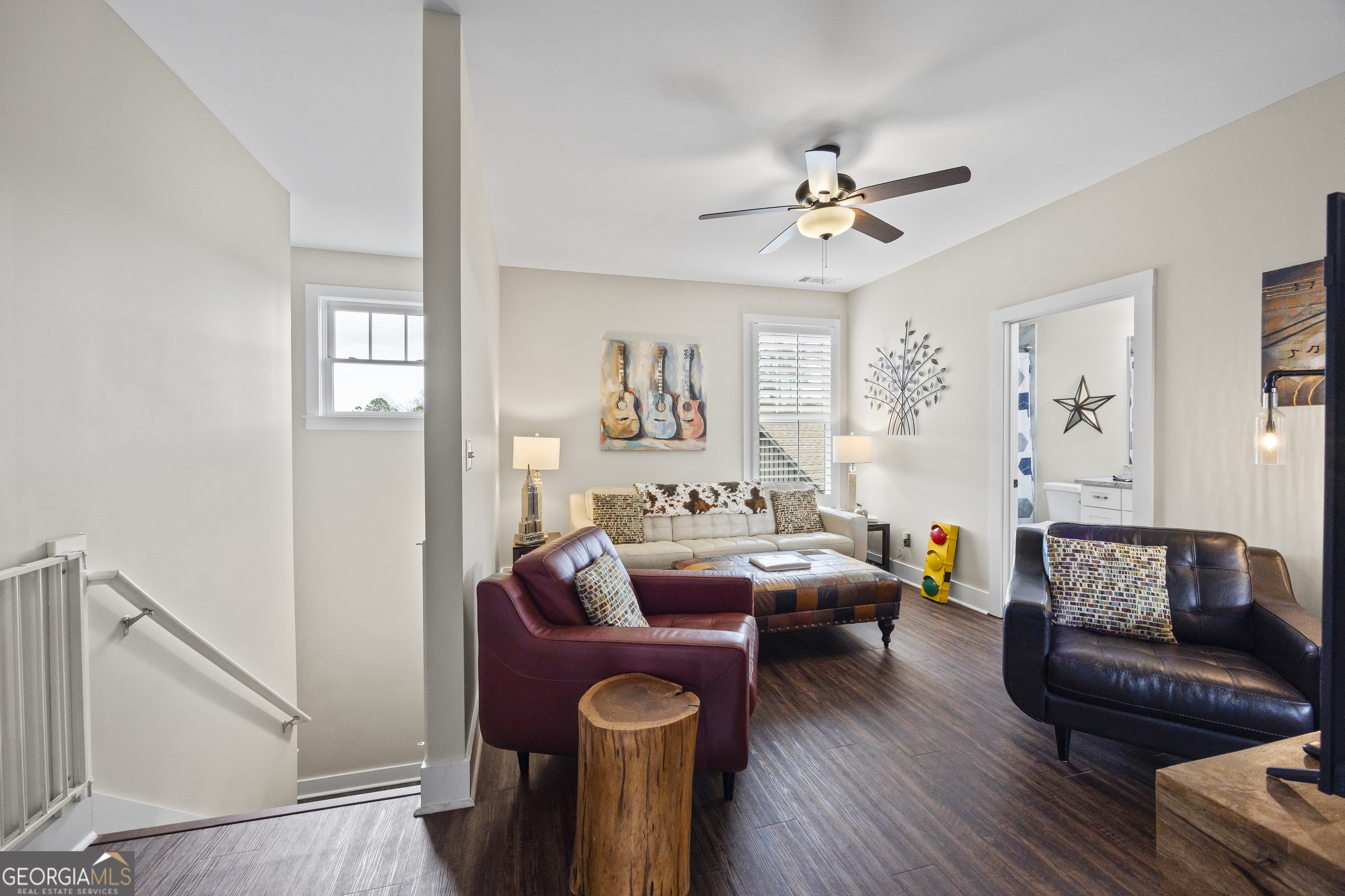 4121 North Swann Street Covington, GA 30014 - Photo 26 of 46 a living room with furniture a ceiling fan and a wooden floor