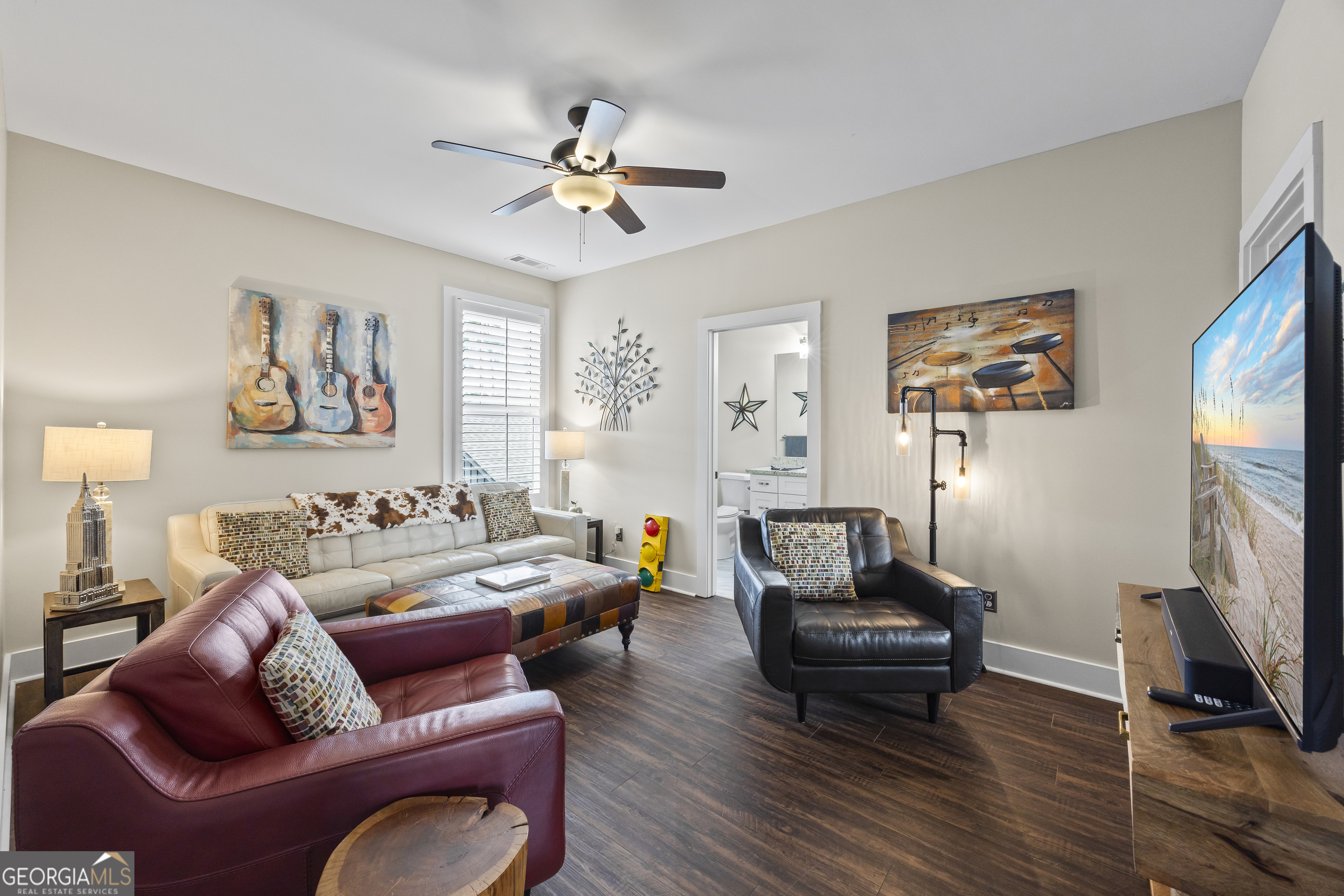 4121 North Swann Street Covington, GA 30014 - Photo 27 of 46 a living room with furniture ceiling fan and a wooden floor