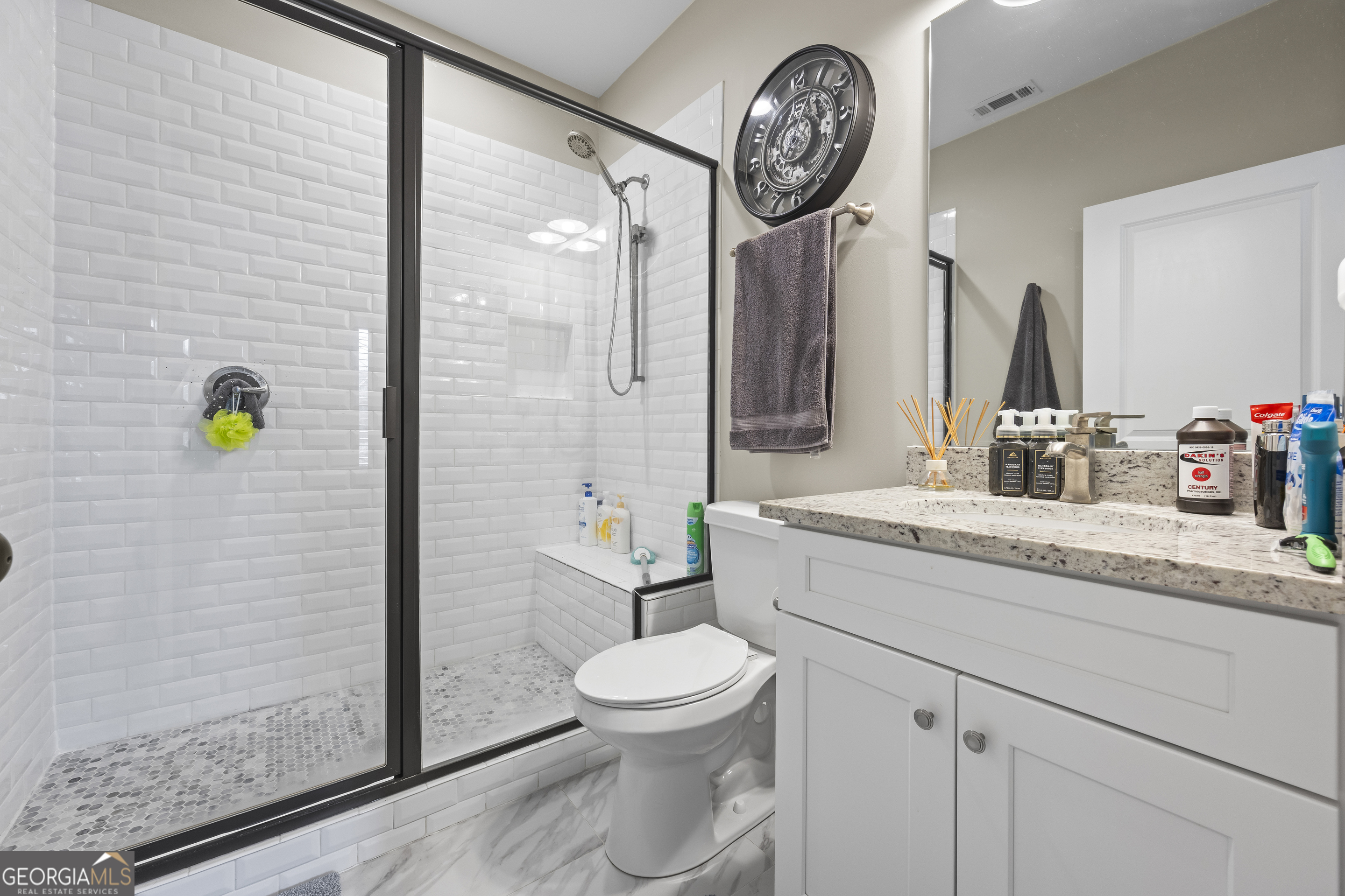 4121 North Swann Street Covington, GA 30014 - Photo 31 of 46 a bathroom with a granite countertop sink a toilet and a mirror