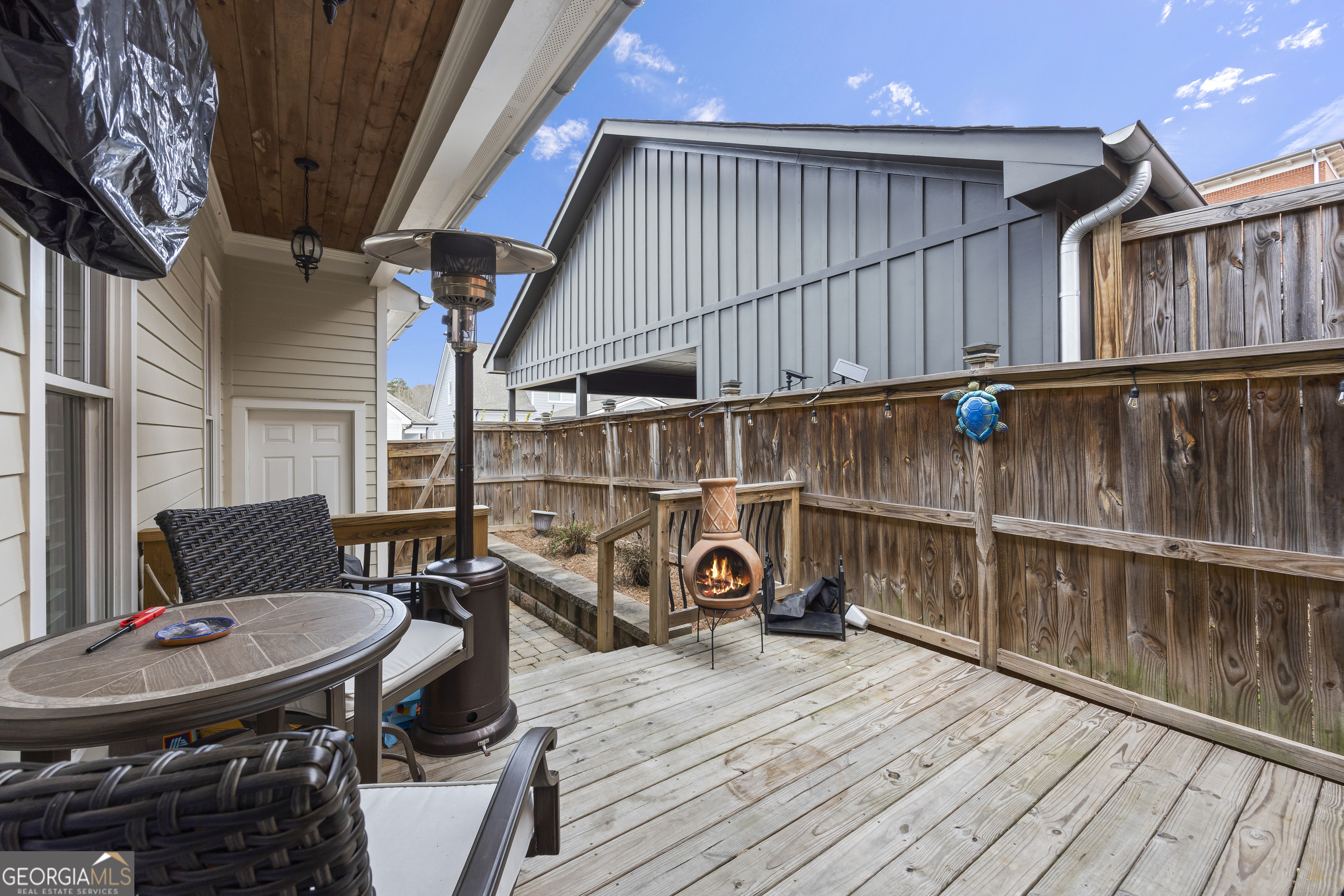 4121 North Swann Street Covington, GA 30014 - Photo 36 of 46 a view of a patio with table and chairs with wooden floor and fence