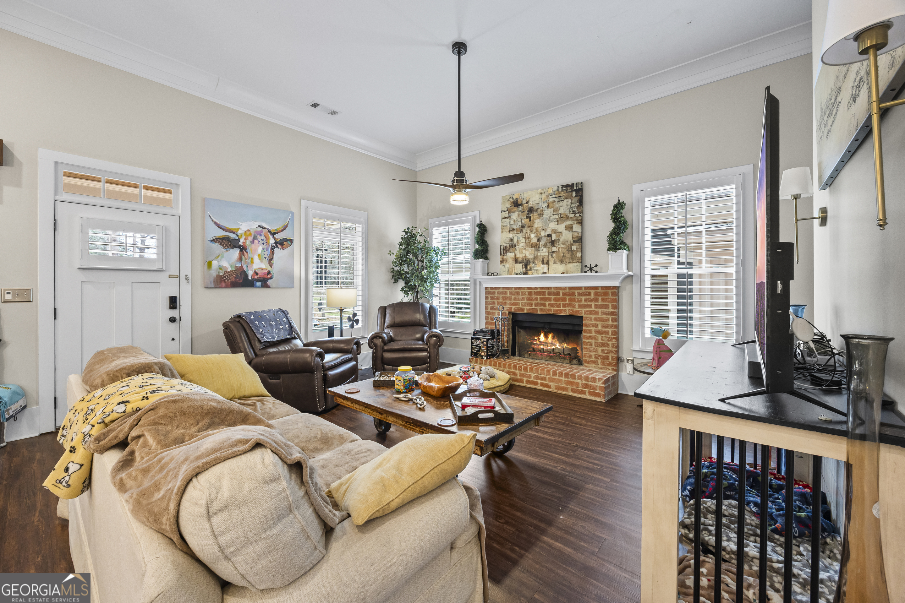 4121 North Swann Street Covington, GA 30014 - Photo 7 of 46 a living room with furniture a fireplace and a flat screen tv