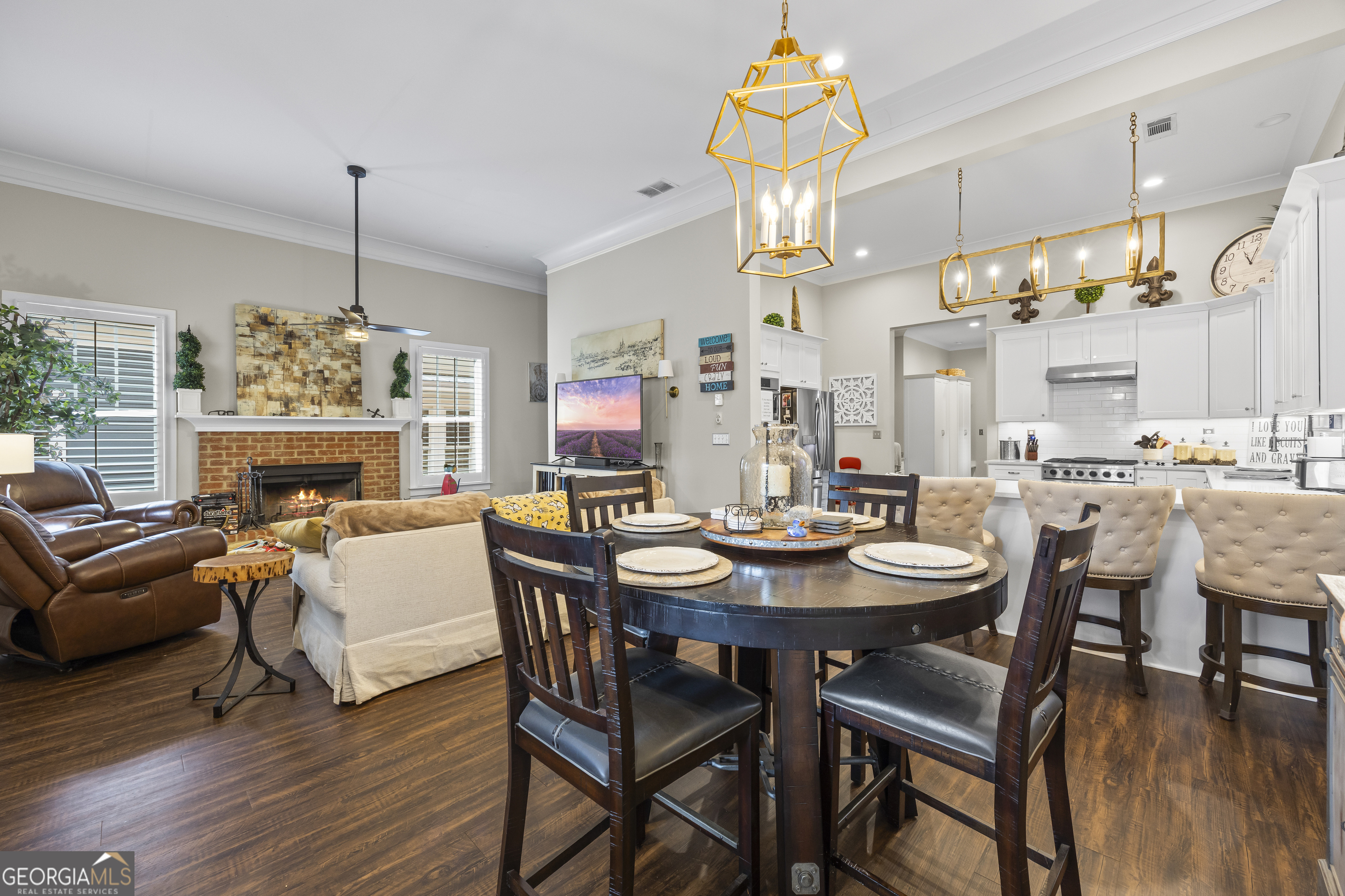 4121 North Swann Street Covington, GA 30014 - Photo 10 of 46 a view of a dining room with furniture wooden floor and chandelier