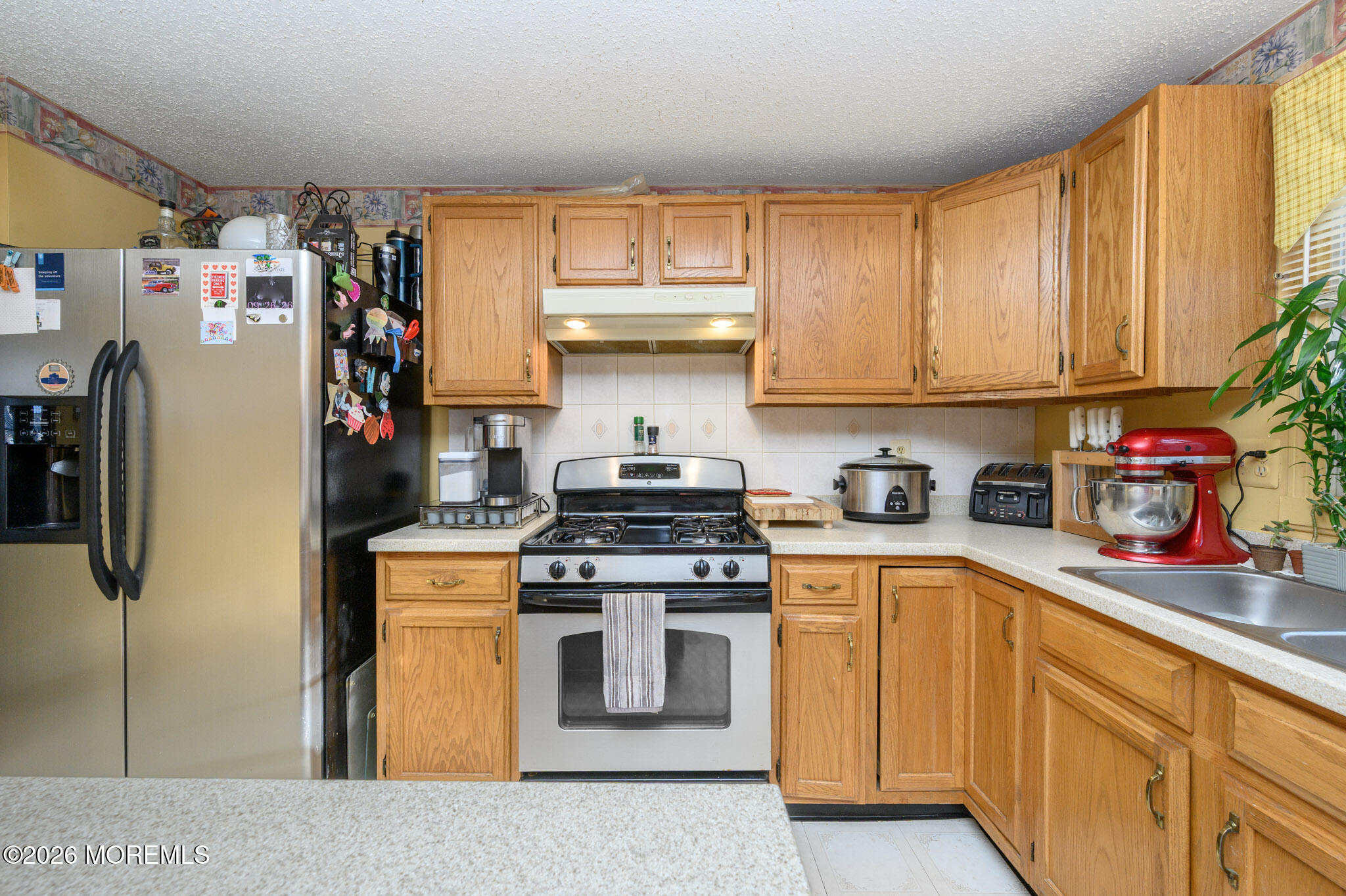 33 Compass Lane Barnegat, NJ 08005 - Photo 10 of 30 a kitchen with stainless steel appliances granite countertop a stove and a refrigerator